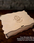 Wooden box with engraved design on a dark surface