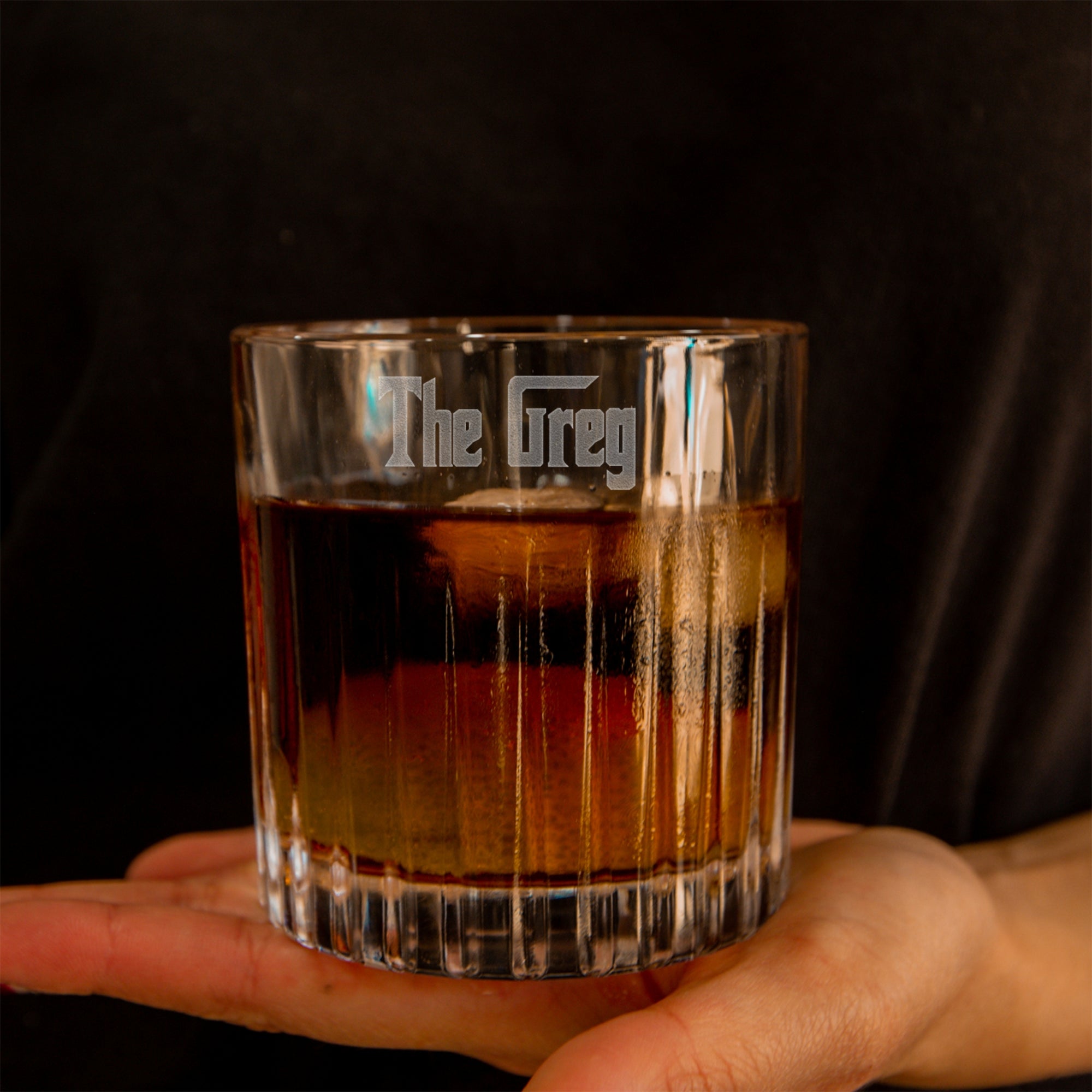 Glass of whiskey held by a hand with &#39;The Grey&#39; by Yoonek Gifts