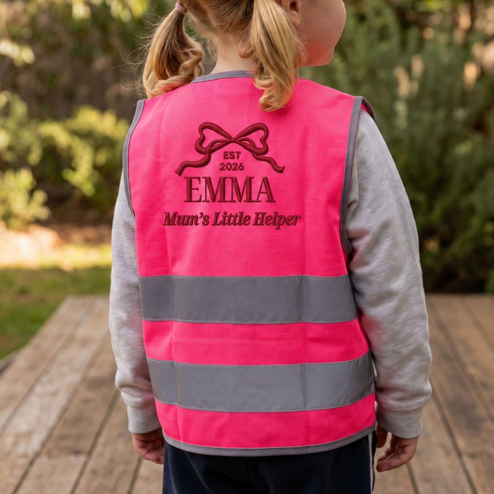 Close-up of embroidered name on back of kids hi-vis safety vest
