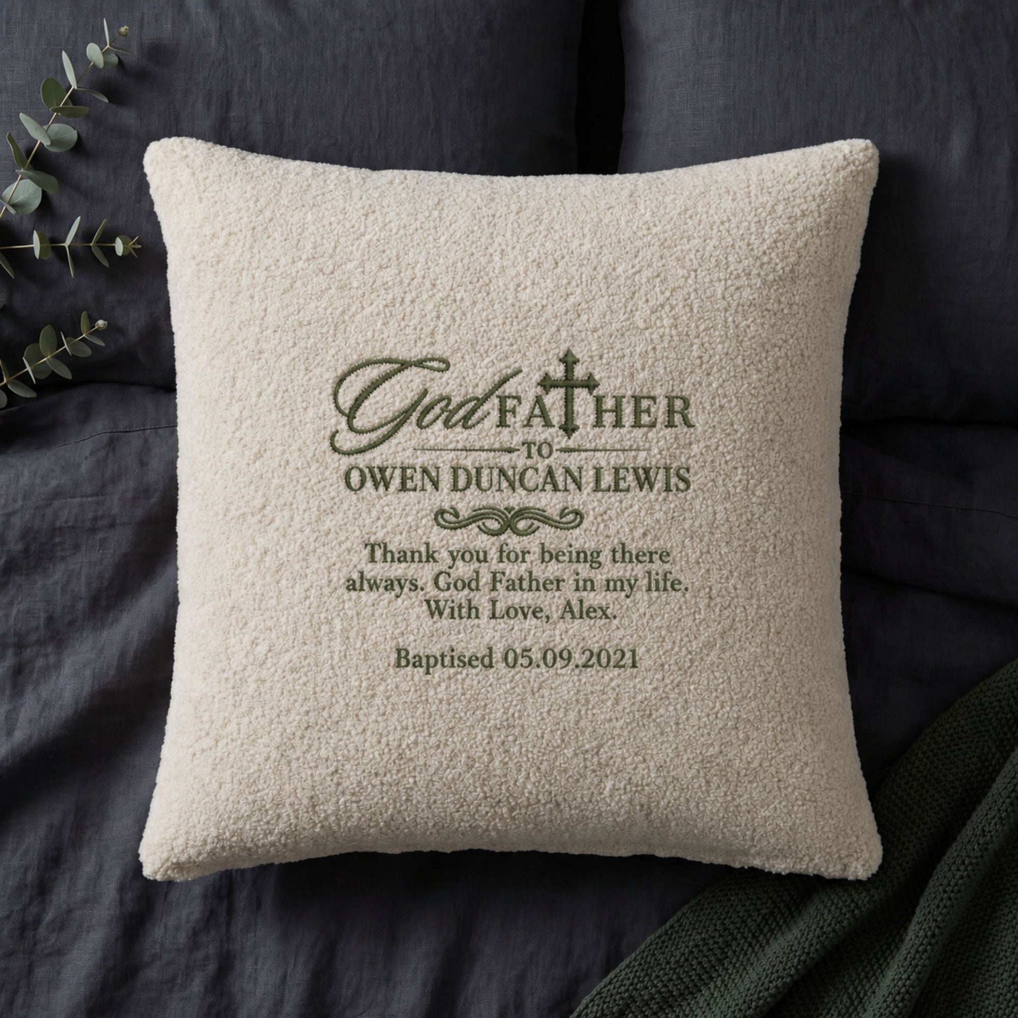 Close-up of embroidered custom name on soft teddy pile cushion cover