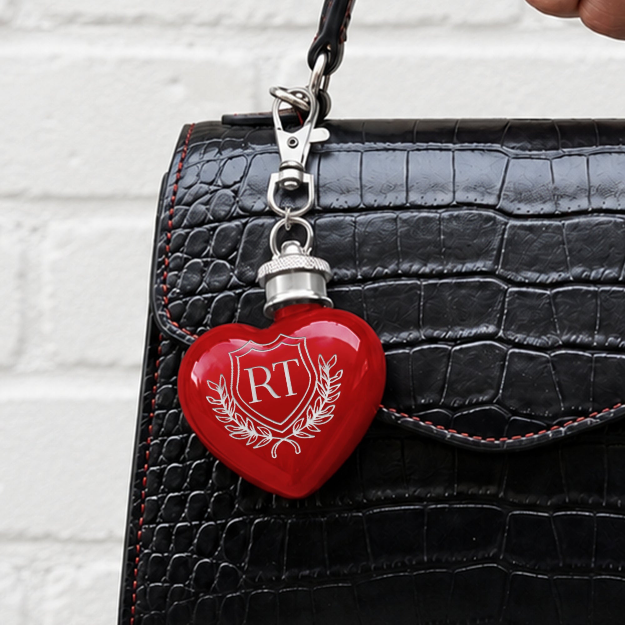 Close-up of engraved name on personalised heart mini hip flask keyring