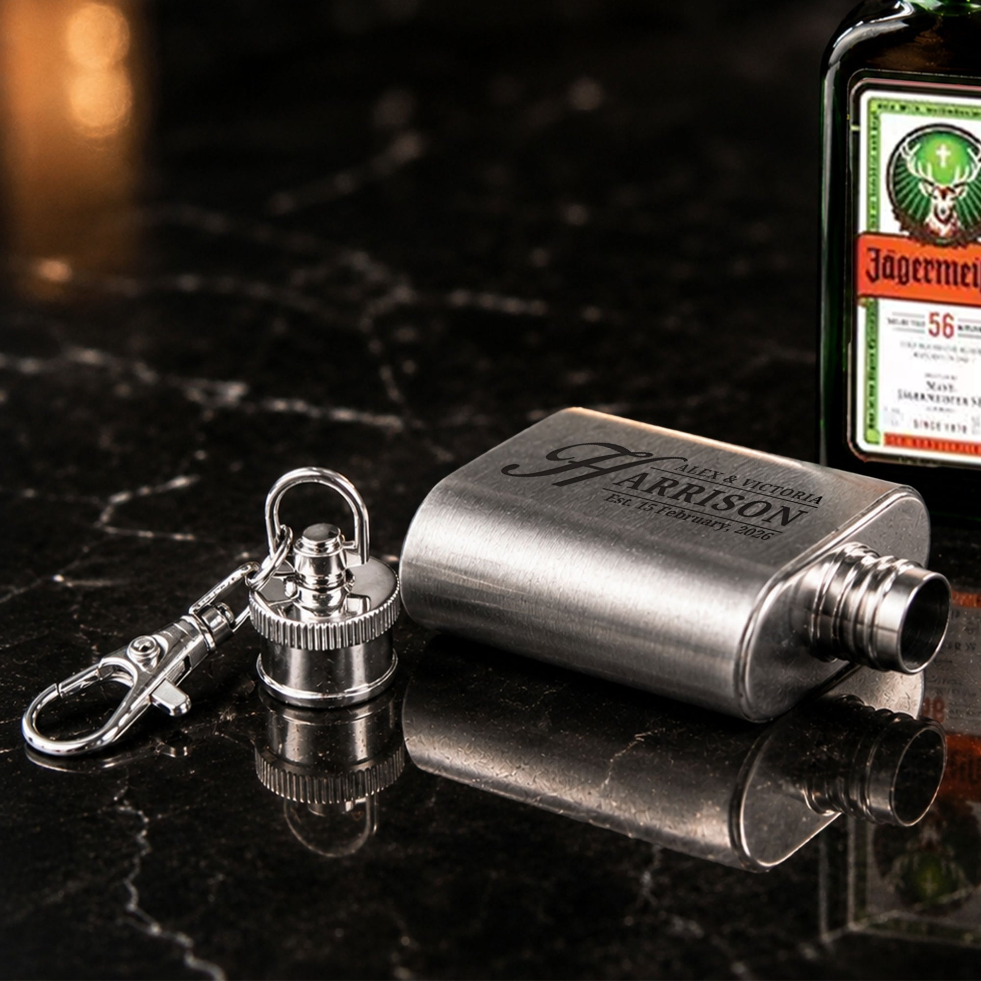 Close-up of laser engraved name on personalised 1oz mini hip flask keyring