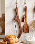 Engraved wooden bread knife in kitchen
