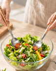 Personalised engraved acacia wood and silver salad servers tossing a salad