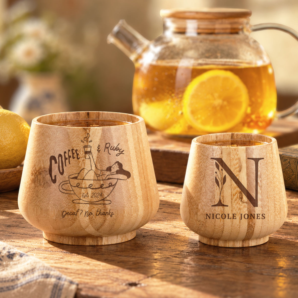 Two personalised engraved bamboo cups in small and large sizes with tea