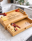 Personalised engraved bamboo serving tray with pull-out drawer, used as a charcuterie cheeseboard