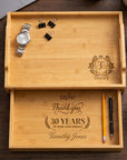 Personalised bamboo valet tray with pull-out drawer on a desk holding a watch and stationery