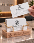 Personalised beech business card holder with brass stand at a reception counter