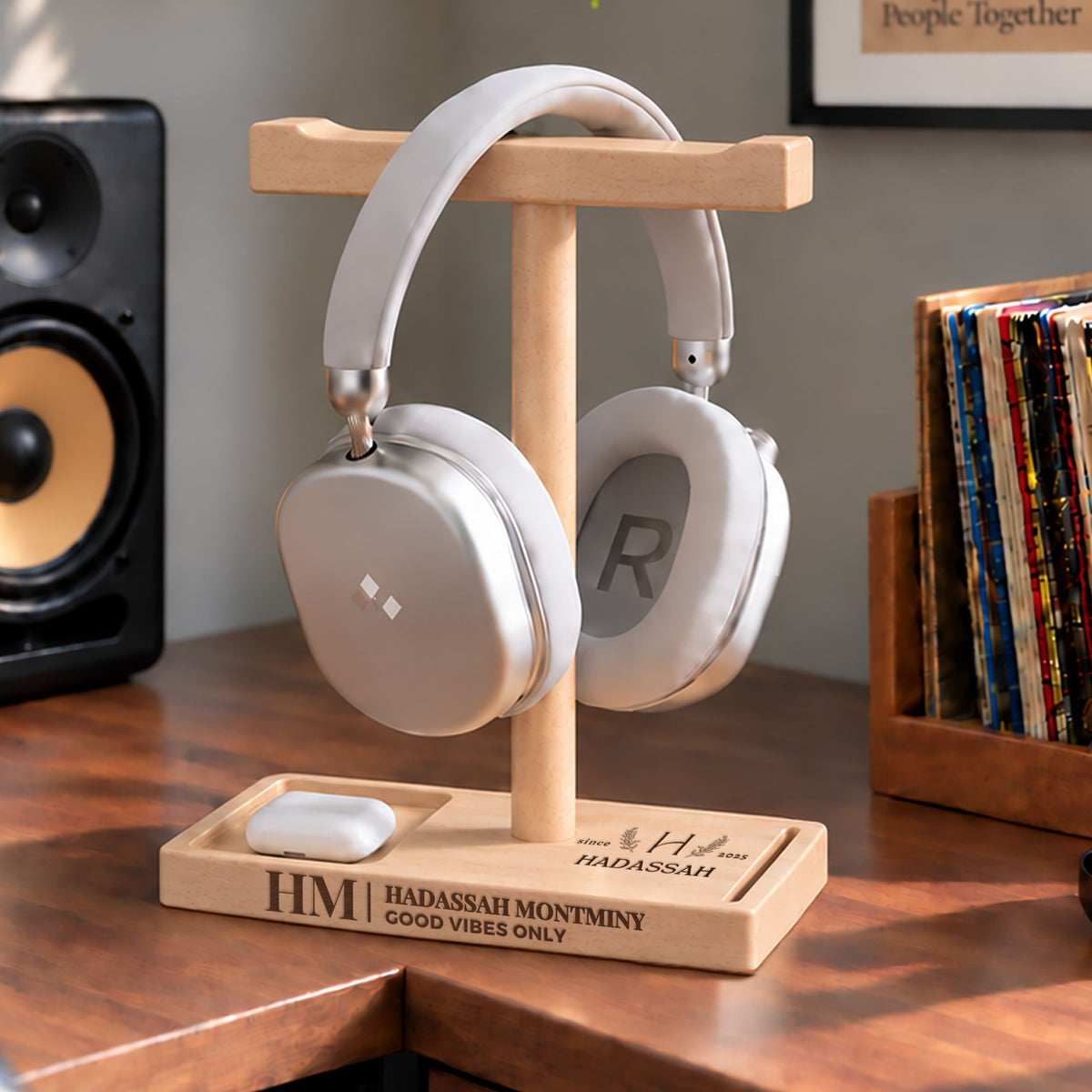 Personalised beech headphone stand holding headphones with an engraved name and storage tray