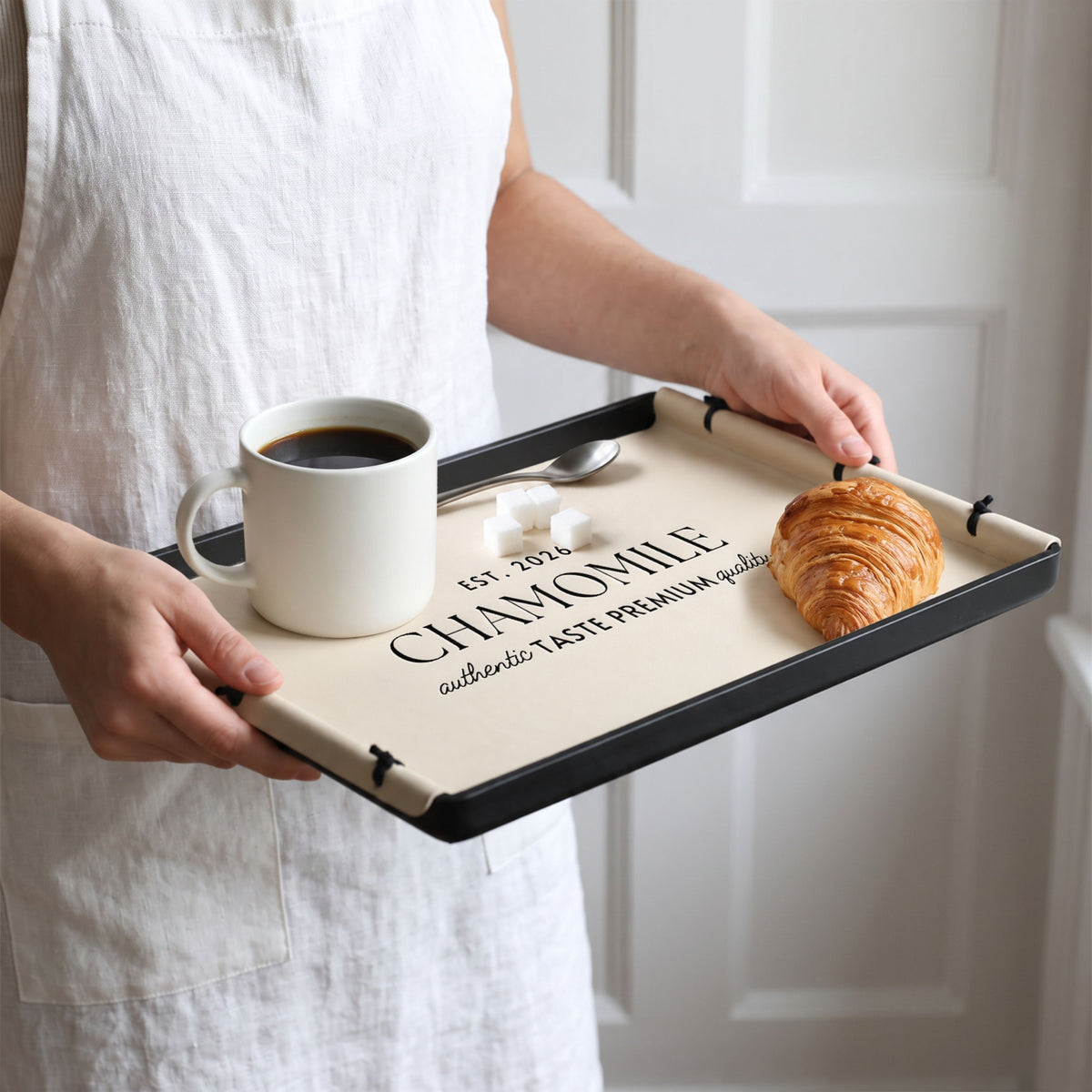 Personalised beige leatherette serving tray with coffee and a croissant, engraved with a name