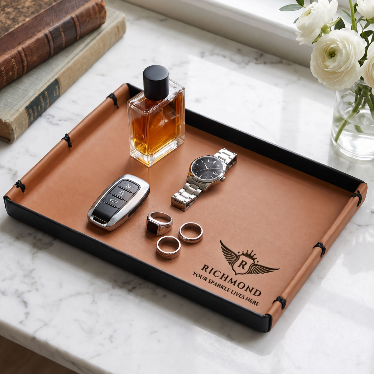 Personalised brown leatherette vanity tray holding a watch, keys and perfume, engraved with a logo