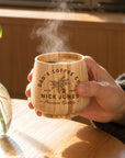 Personalised engraved bamboo coffee cup held with steaming coffee