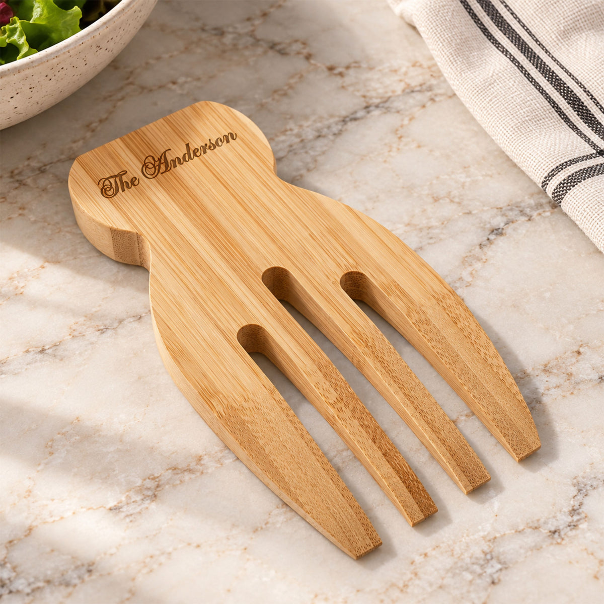 Personalised bamboo salad hands close up engraving detail