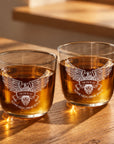 Two personalised engraved glass tumblers with whisky and an eagle design