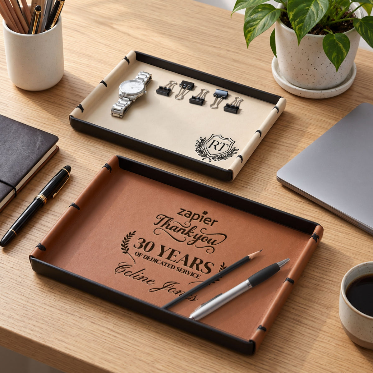 Personalised leatherette serving trays in brown and beige, engraved on a desk