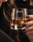 Personalised rocks whisky glass engraved with a name, held with whisky