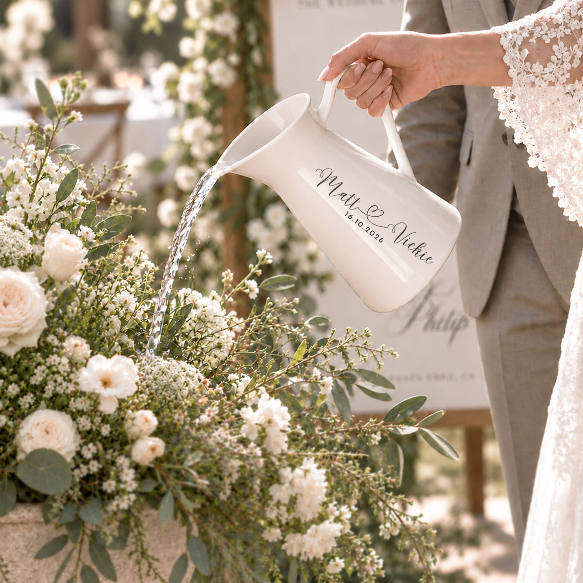 Personalised white enamel jug used as a watering can, engraved for a wedding