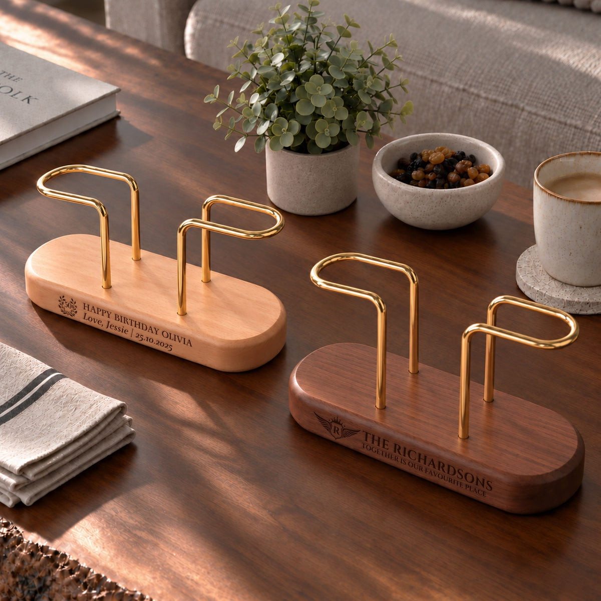 Beech and walnut brass napkin holders with engraved bases on a table