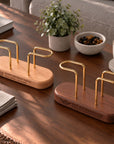 Beech and walnut brass napkin holders with engraved bases on a table