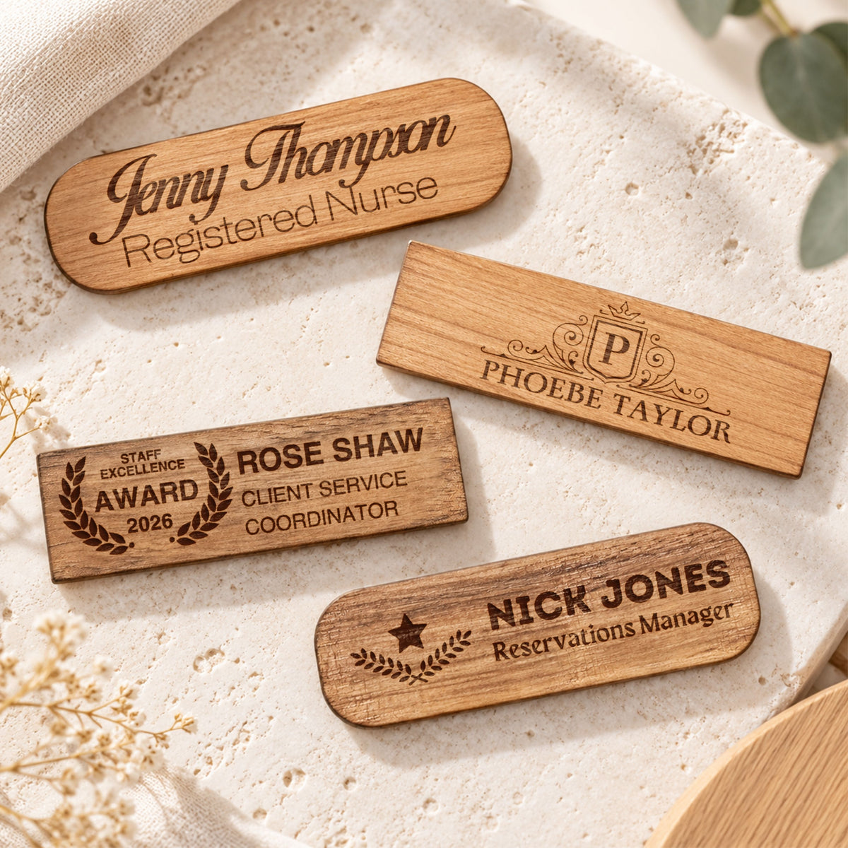 Personalised engraved wooden name badges in cherry and walnut, oval and rectangle shapes