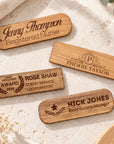 Personalised engraved wooden name badges in cherry and walnut, oval and rectangle shapes