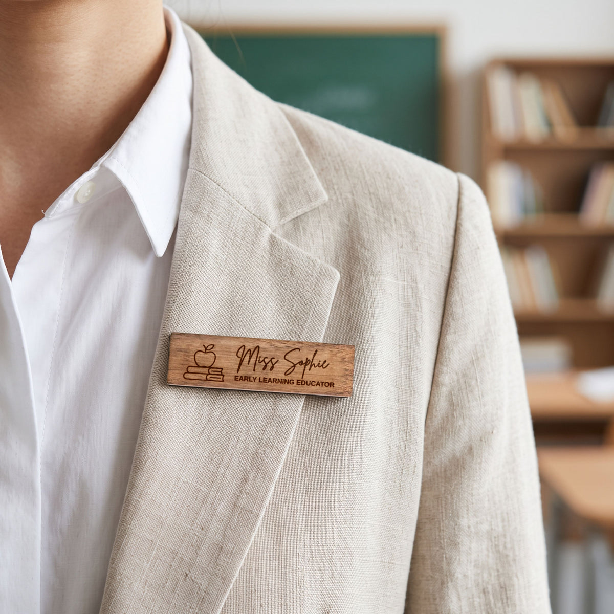 Personalised rectangle wooden name badge worn on a blazer, engraved with a name and role