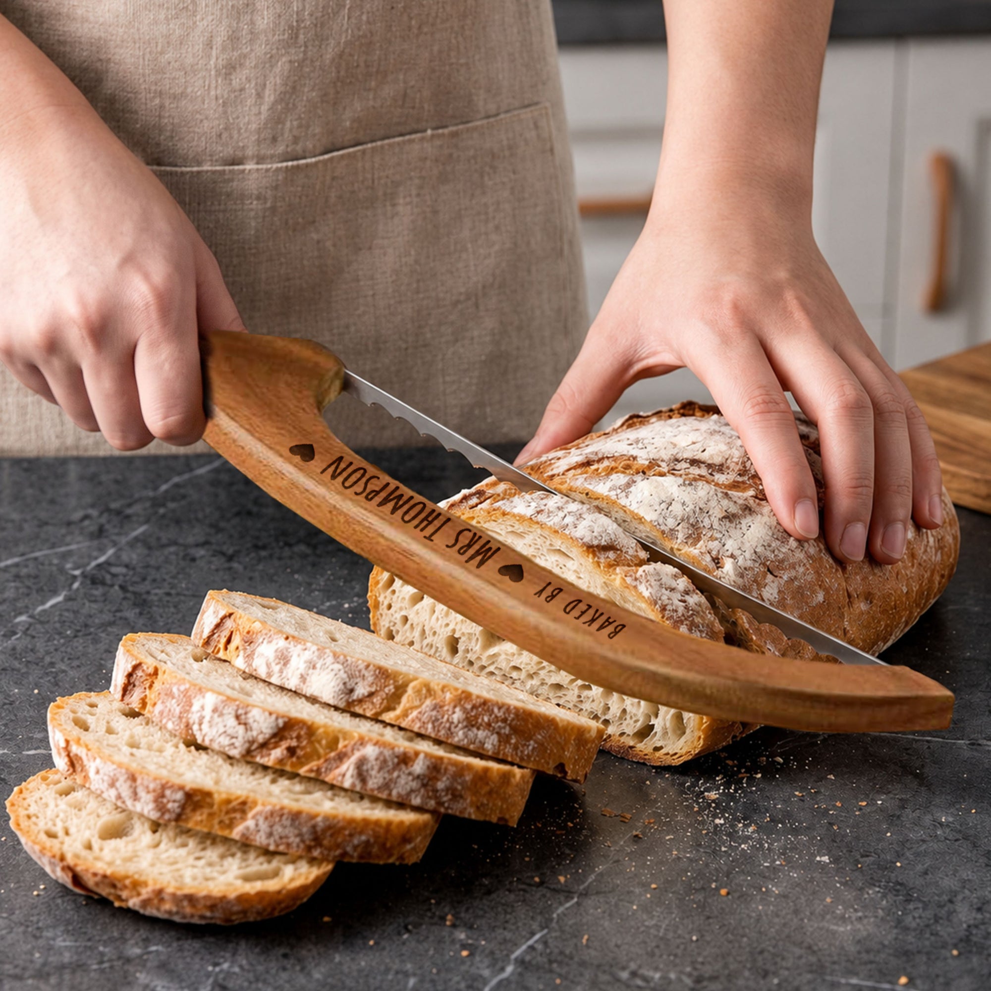 Wooden bread knife slicing sourdough loaf